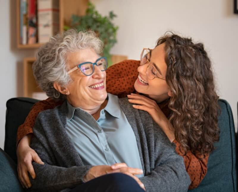 Grandmother and granddaughter embracing warmly