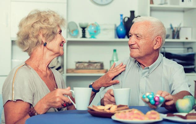 Senior couple enjoying afternoon tea with live-in care support in Ipswich