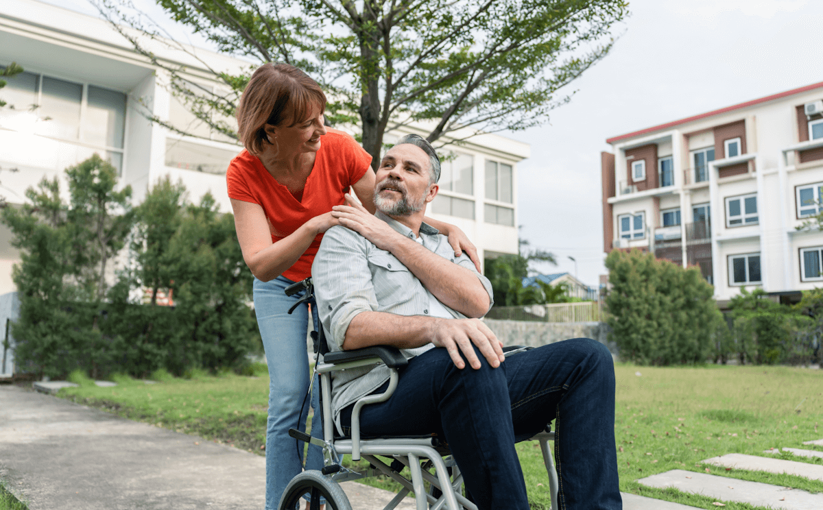 Carer supporting a client outdoors