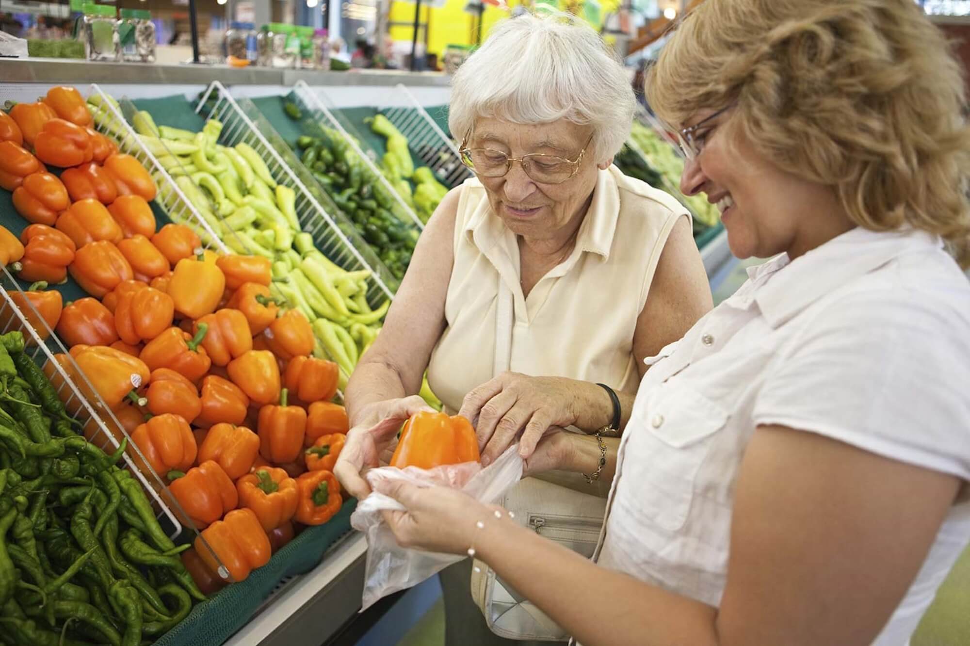 Companion carer helping senior with grocery shopping in Bath